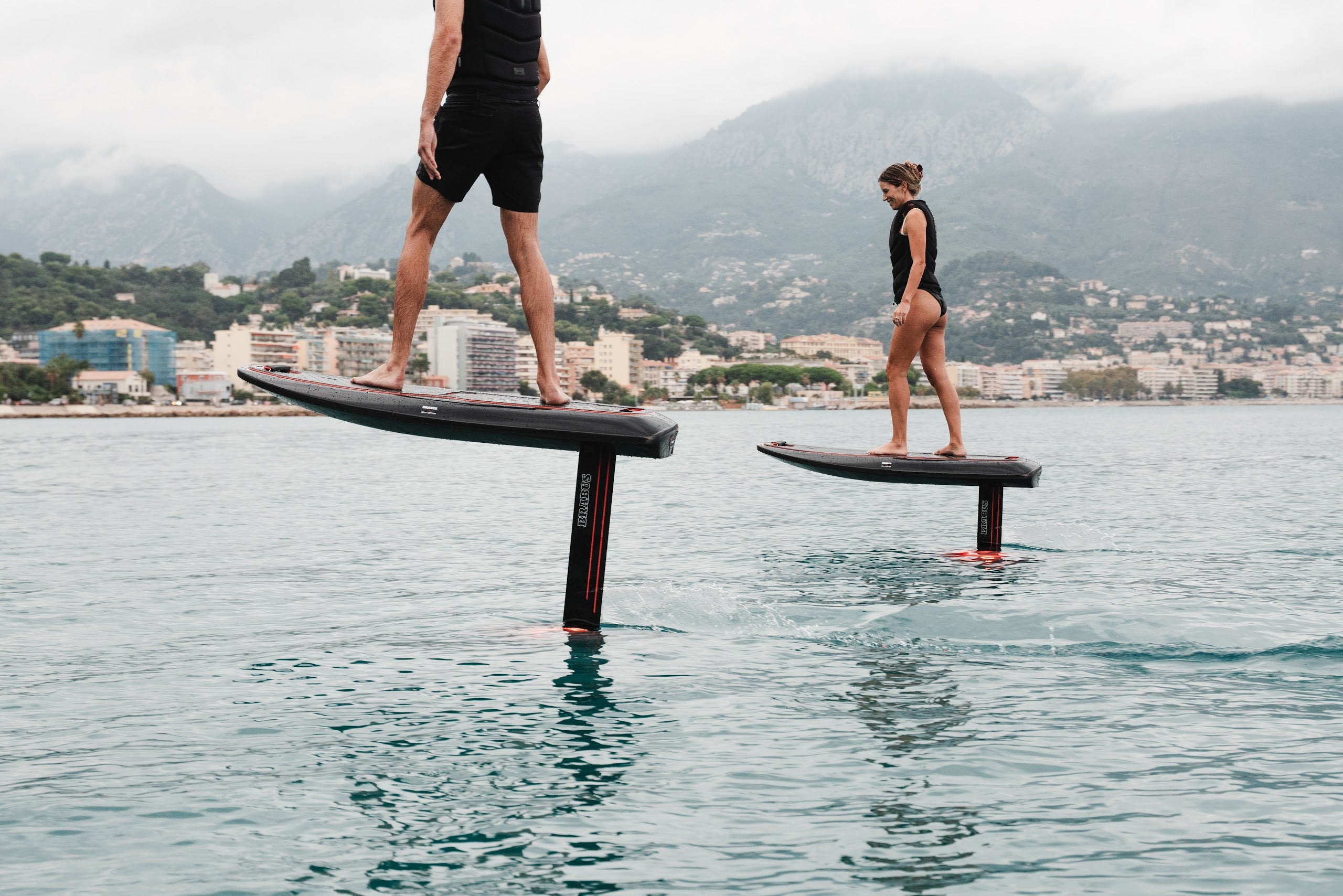Two BRABUS x Awake SHADOW CARVE eFoils riding along the Monaco coast