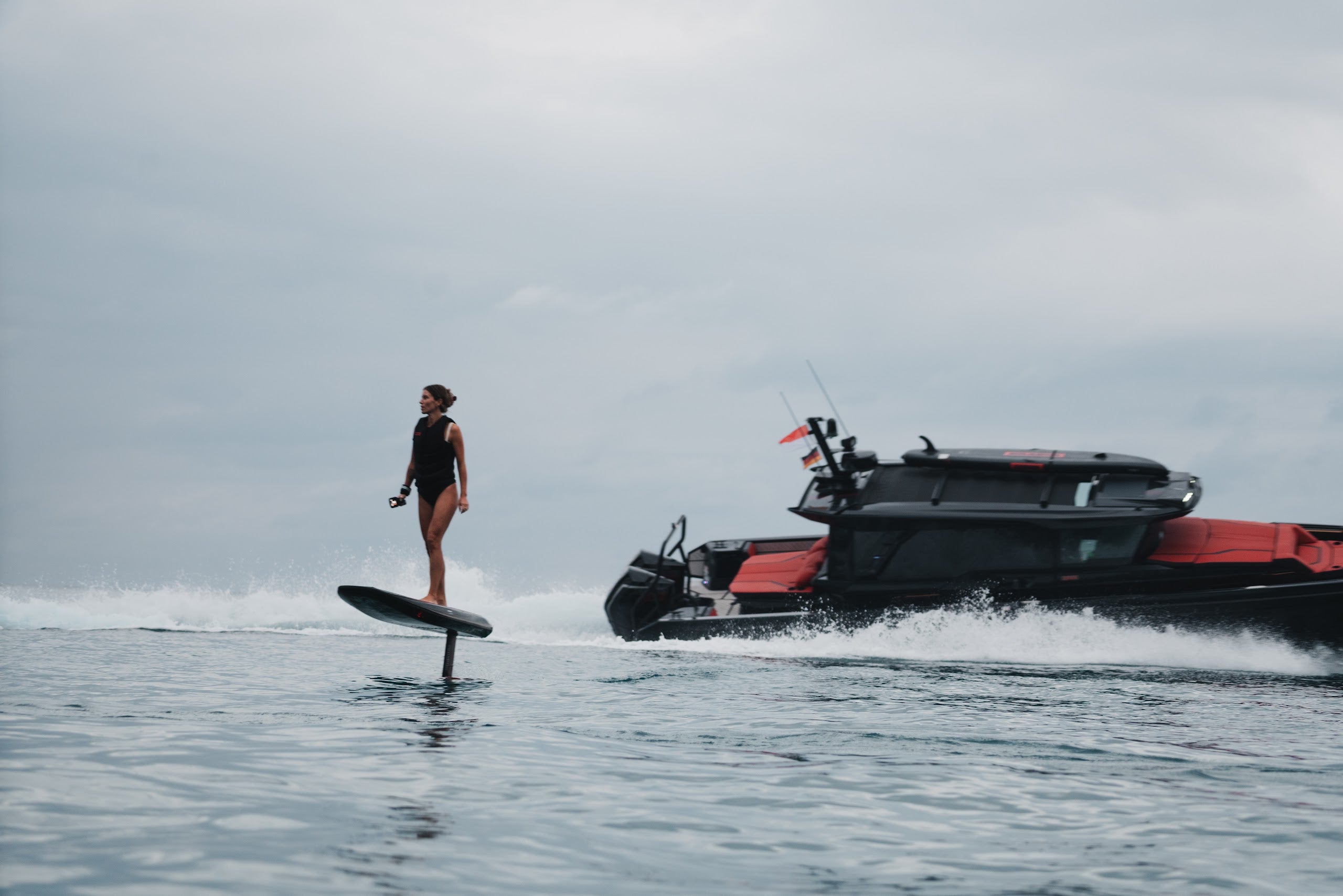BRABUS x Awake SHADOW CARVE eFoil riding alongside a BRABUS boat