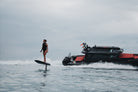 BRABUS x Awake SHADOW CARVE eFoil riding alongside a BRABUS boat