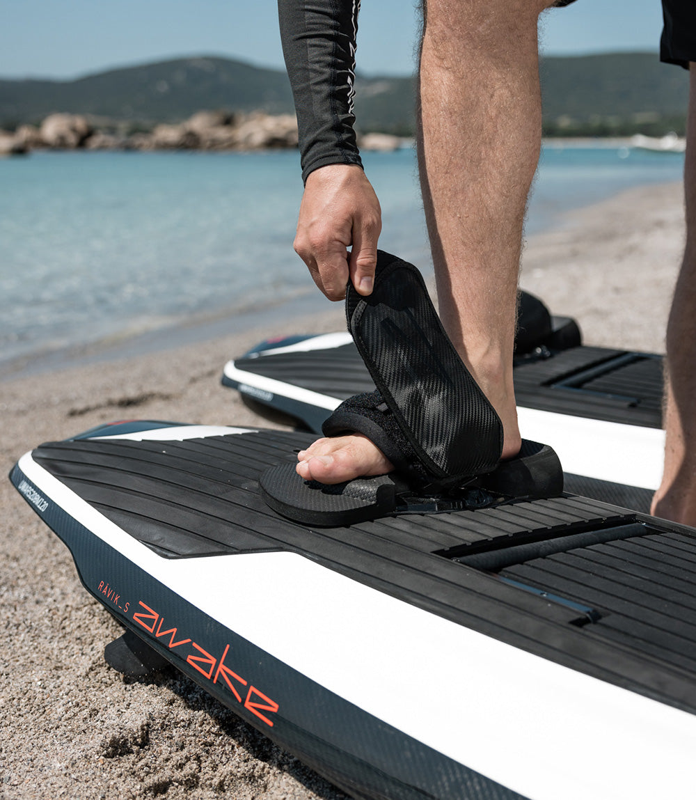 A man strapping on the Awake Foot Straps